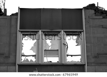 A photograph of a building exterior during the demolition process.