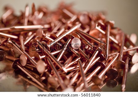 Copper Nails on Galvanized Steel Background With Shallow Focus