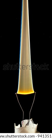 An electical element in a light bulb igniting and burning out