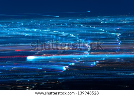 Abstract pattern of city lights from cars, windows, streetlights and bars