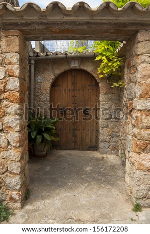 Old wooden door of house in mountain village Valldemossa, Mallorca, Spain