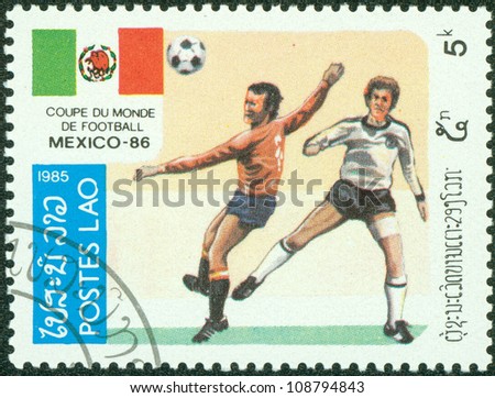 LAOS - CIRCA 1985: A Stamp printed in LAOS shows the Soccer Players, Football Field and flag of Mexico, series, circa 1985