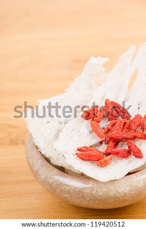 Edible bird\'s nest with chinese wolfberry fruit on table