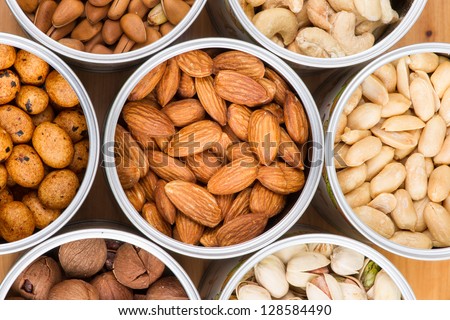 Assorted nuts in Iron pot (pecan, pistachios, almond, peanut, cashew,Pine nuts?
