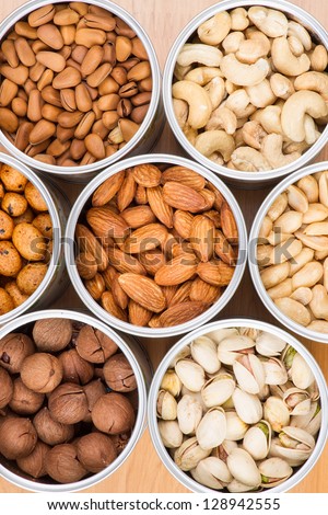 Assorted nuts in Iron pot (pecan, pistachios, almond, peanut, cashew,Pine nuts?
