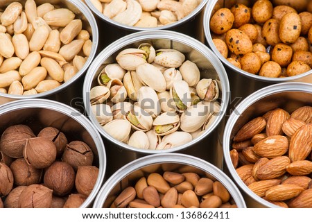 Assorted nuts in Iron pot (pecan, pistachios, almond, peanut, cashew,Pine nuts)