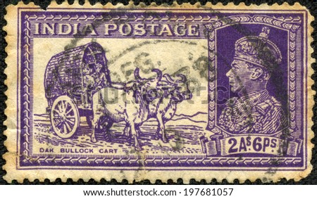 INDIA - CIRCA 1937: A stamp printed in India shows Bullock cart and King George VI, circa 1937.