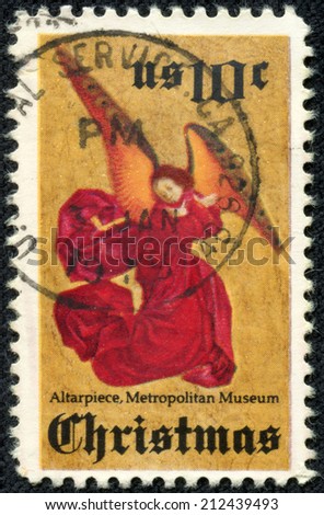 USA - CIRCA 1974: A stamp printed in USA shows an angel in red gown against golden back ground. It is done by an anonymous French artist from 1480, circa 1974