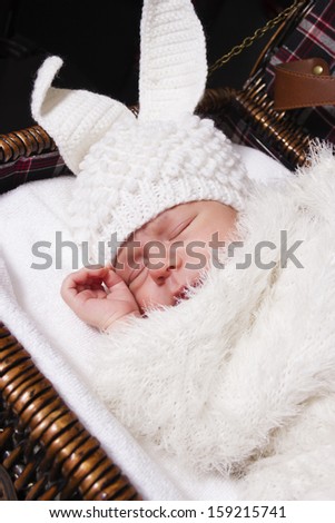 the sleeping baby in a suit of a rabbit