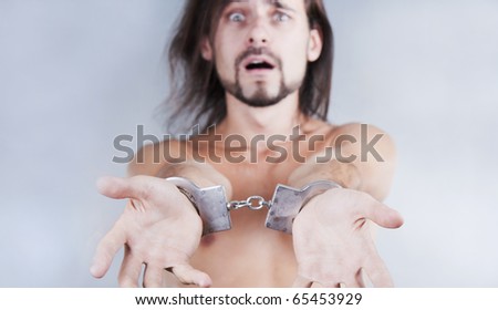 chained in handcuffs long-haired caucasian guy