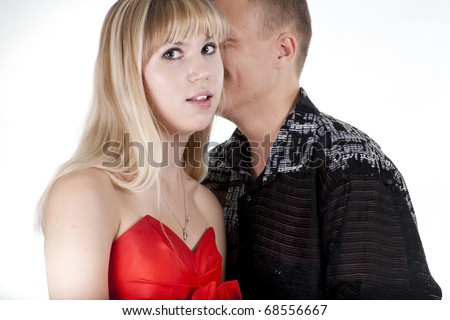The young man whispers something to the blonde girl
