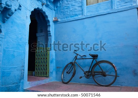 Bicycle parked in front of the house painted in \
