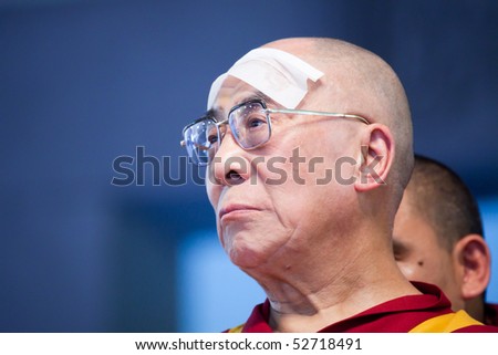 HARIDWAR, INDIA - APRIL 3: Dalai Lama cooling off with a tissue during an event at Kumbh Mela festival April 3, 2010 in Haridwar, India.
