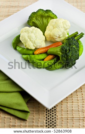 Vegetables On White Plate With Bamboo Placemat and Napkin