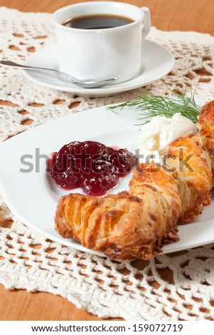 Light meal with coffee, bread and jam.