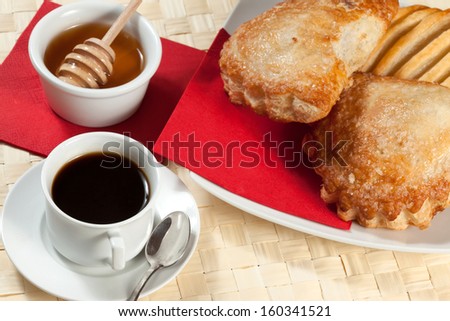 Breakfast including coffee, bread, honey.