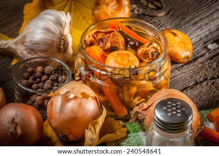 Delicious marinated mushrooms, oil and spices on wooden table. Selective focus.