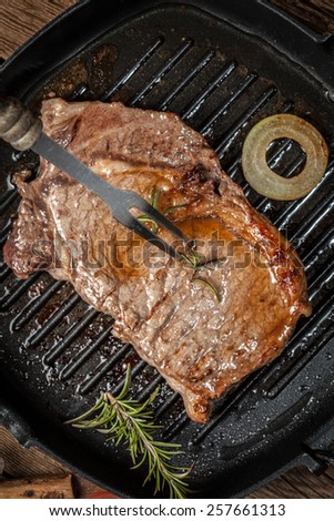 Fried beef steak in a frying pan.