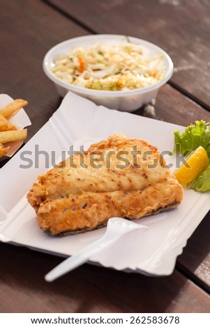 Fried fish on a paper plate. Selective focus.