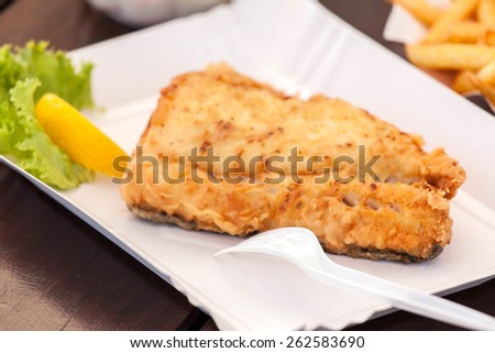 Fried fish on a paper plate. Selective focus.