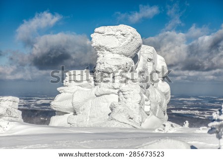 Winter landscape with snow covered rocks.. Krkonose mountains.