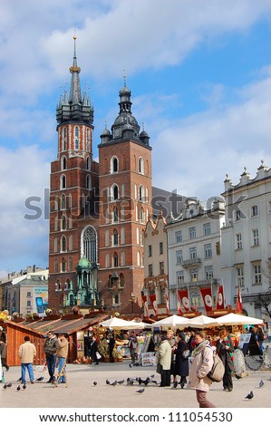 KRAKOW, POLAND - MARCH 14: Tourists at the Market Square before Easter, on March 14,  2008 in Krakow Poland. Main Market Square, one of the largest medieval squares in Europe, was built in 1257.