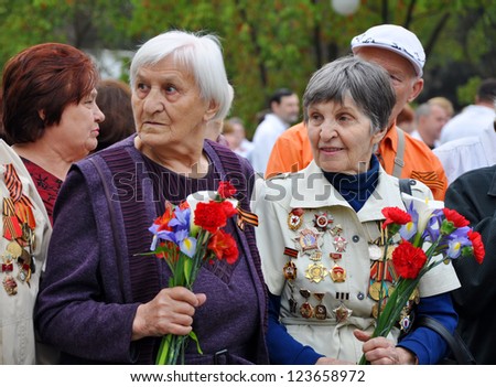 SOCHI, RUSSIA - MAY 9: Women - World War II veterans with flowers in their hands celebrate Victory Day on May 9, 2012 in Sochi, Russia.