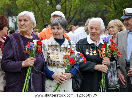 SOCHI, RUSSIA - MAY 9: Women - World War II veterans with flowers in their hands celebrate Victory Day on May 9, 2010 in Sochi, Russia.