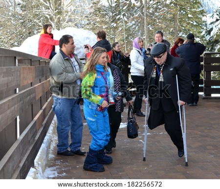 SOCHI, RUSSIA - MARCH 16, 2014: Transportation volunteers help fans with disabilities in the mountain cluster during the XI Paralympic Games