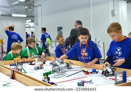 SOCHI, RUSSIA - November 21, 2014: Schoolchildren Team Russia with many robots on the playing field during Robofest on World Robot Olympiad Russia 2014. It was attended by delegates from 47 countries