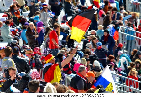 SOCHI, RUSSIA - March 16, 2014: Sport fun man with national flag of Germany on Winter Paralympic Games  in Sochi. Giant Slalom, final day.