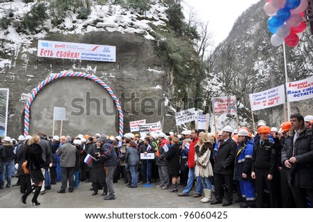 SOCHI, RUSSIA - FEBRUARY 15:Construction workers hold posters and headers with slogans in support of Vladimir Putin on presidential elections of the Russian Federation on February 15, 2012 in Sochi.