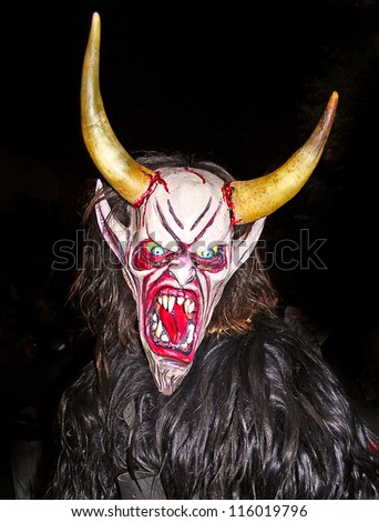 THUMERSBACH, AUSTRIA - DECEMBER 4: Unidentified man wears Krampus (devil) mask at traditional procession on December 4, 2006 in Thumersbach.