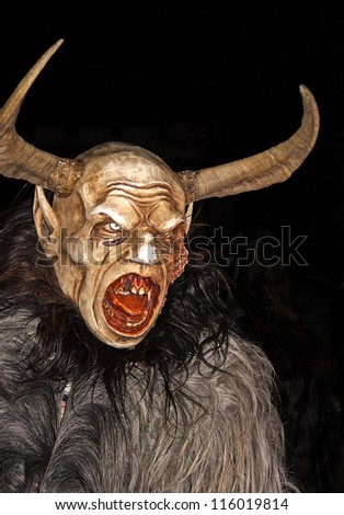 THUMERSBACH, AUSTRIA - DECEMBER 4: Unidentified man wears Krampus (devil) mask at traditional procession on December 4, 2006 in Thumersbach.