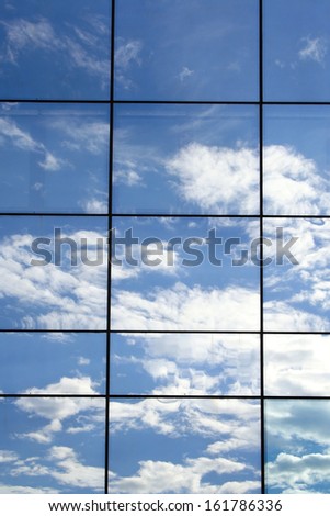 Modern Glass Architecture - clouds reflection in the glass facade