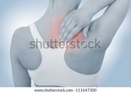 Acute pain in a woman neck. Female holding hand to spot of neck-aches. Concept photo with Color Enhanced blue skin with read spot indicating location of the pain.
