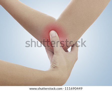 Acute pain in a woman elbow. Female holding hand to spot of elbow pain. Concept photo with Color Enhanced skin with read spot indicating location of the pain.