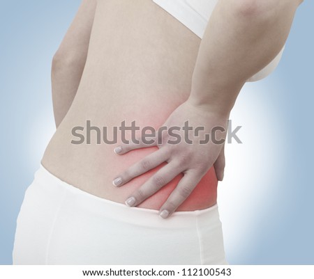 Acute pain in a woman abdomen. Female holding hand to spot of Abdomen-ache. Concept photo with Color Enhanced skin with read spot indicating location of the pain.
