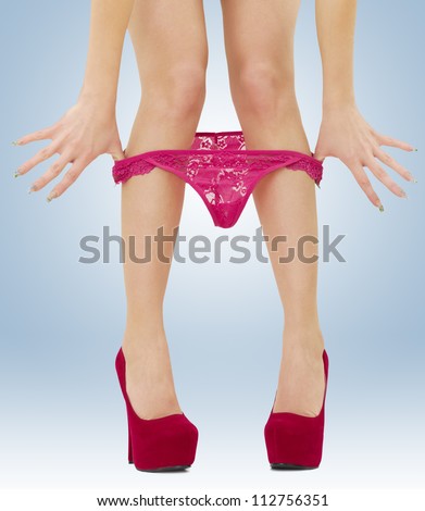 A woman pulls off her panties