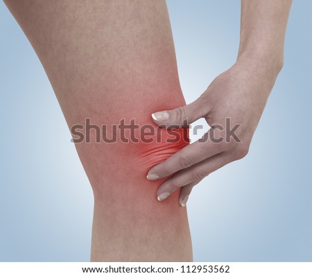 Acute pain in a woman  knee. Female holding hand to spot of knee-aches. Concept photo with Color Enhanced blue skin with read spot indicating location of the pain. Isolation on a white background.
