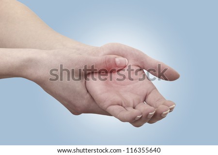 Acute pain in a man palm. Female holding hand to spot of palm-ache. Concept photo with Color Enhanced skin with read spot indicating location of the pain. Isolation on a white background.