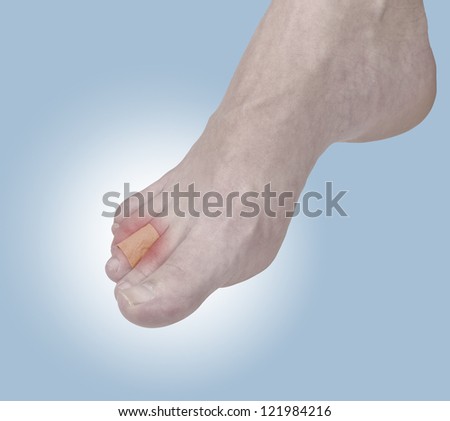 Adhesive Healing plaster on foot finger. Pain concept photo.