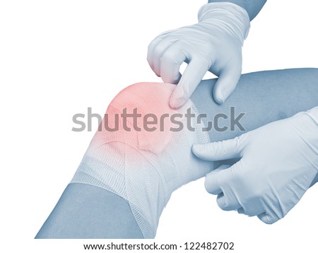 Cotton bandage over a wound on knee. Pain concept photo.