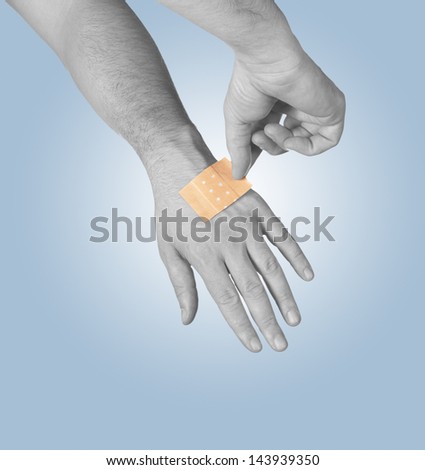 Putting a small adhesive, bandage on arm