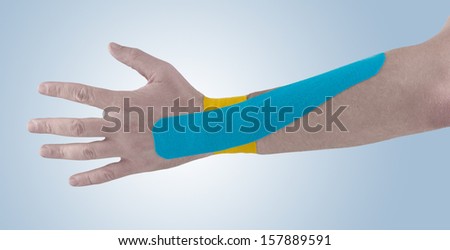 Physiotherapy treatment with therapeutic tape for wrist pain, aches and tension. It  is also used for prevention and treatment in competitive sports.