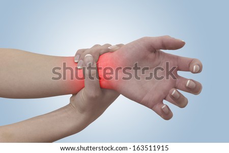 Acute pain in a woman wrist. On light blue background. Color Manipulation image to emphasize the pain.