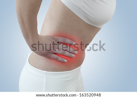Acute pain in a woman kidney. Concept photo with blue skin with read spot indicating pain.