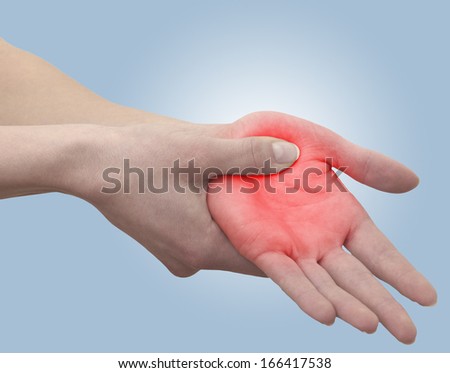 Acute pain in a woman palm. Concept photo with blue skin with read spot indicating pain.