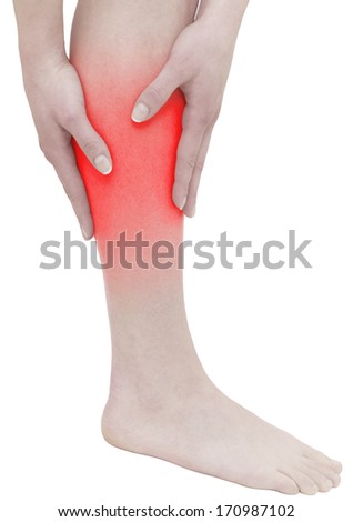 Acute pain in a woman calf. Female holding hand to spot of  calf-aches. Concept photo with Color Enhanced blue skin with read spot indicating location of the pain. Isolation on a white background.
