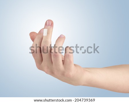Pain in a man fingere. Male holding hand to spot of finger-ache.